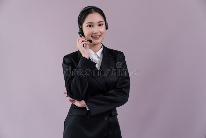 Attractive Asian operator with formal suit and headset. Enthusiastic royalty free stock photo