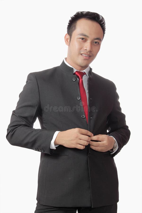 Attractive asian man in suit over white background