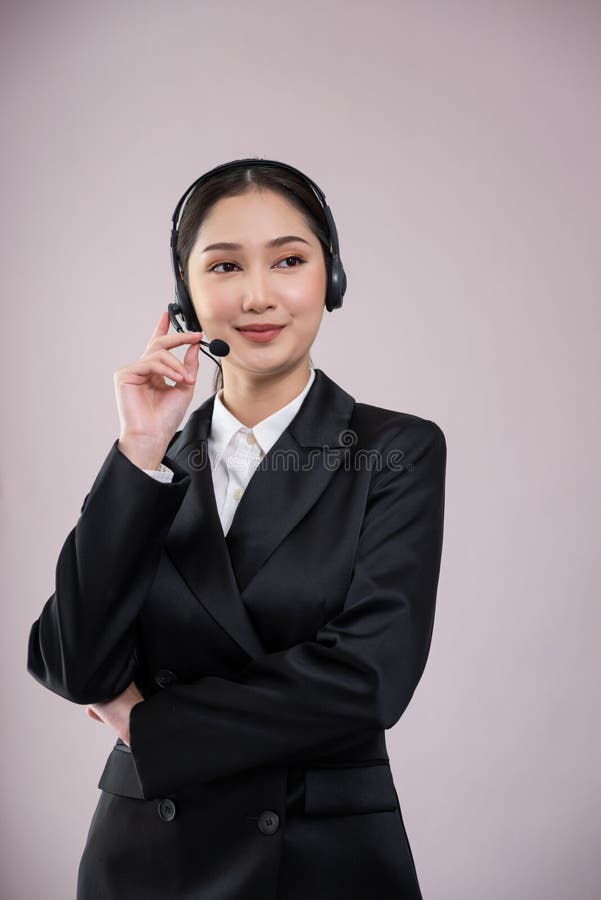 Attractive Asian operator with formal suit and headset. Enthusiastic stock photos