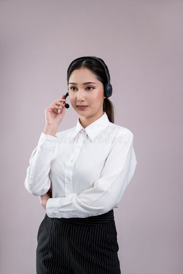 Attractive Asian operator with formal suit and headset. Enthusiastic royalty free stock photos