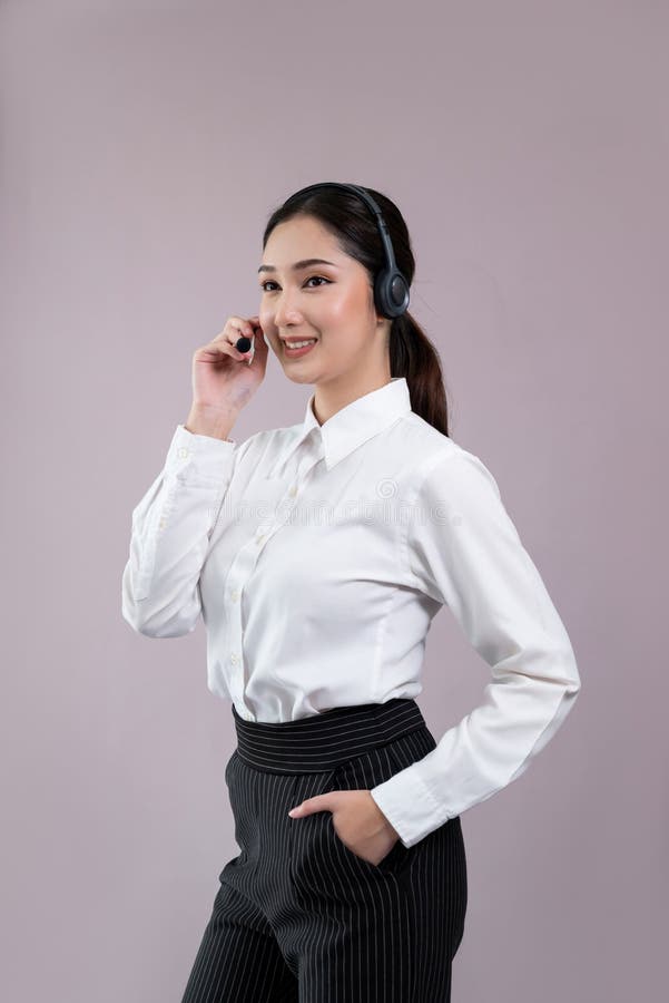 Attractive Asian operator with formal suit and headset. Enthusiastic royalty free stock images