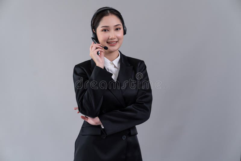 Attractive Asian operator with formal suit and headset. Enthusiastic royalty free stock photo
