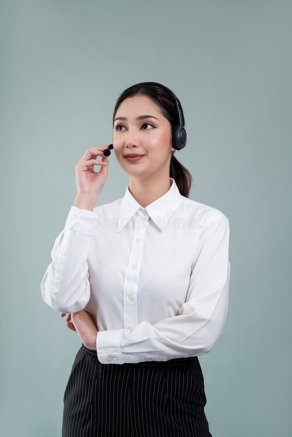 Attractive Asian operator with formal suit and headset. Enthusiastic royalty free stock photo