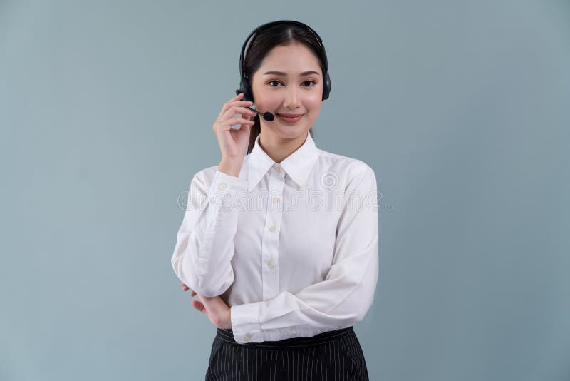 Attractive Asian operator with formal suit and headset. Enthusiastic royalty free stock photography