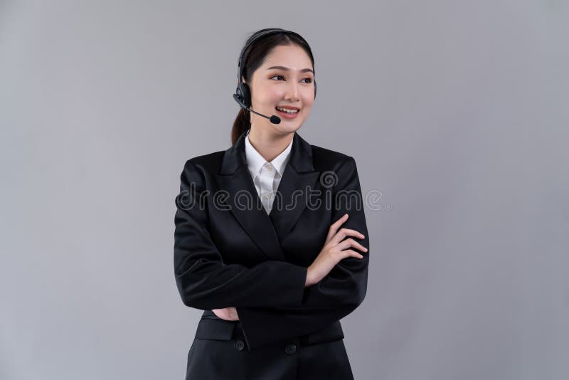 Attractive Asian operator with formal suit and headset. Enthusiastic stock image