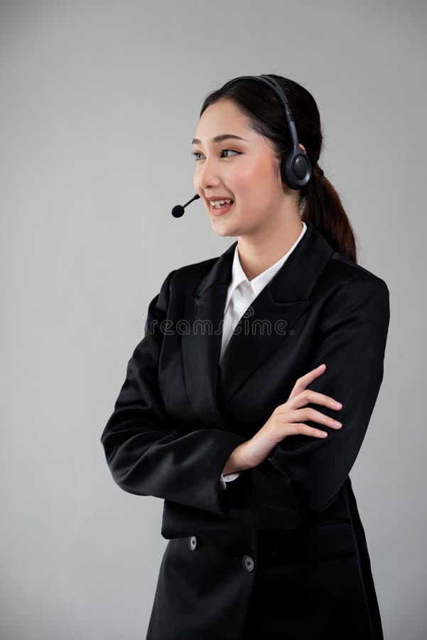 Attractive Asian operator with formal suit and headset. Enthusiastic stock photo