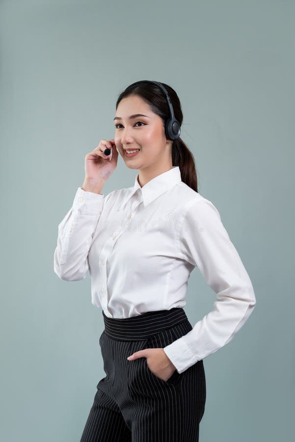 Attractive Asian operator with formal suit and headset. Enthusiastic royalty free stock photography