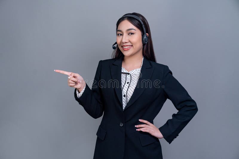 Attractive Asian operator with formal suit and headset. Jubilant royalty free stock photos