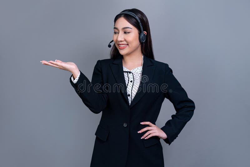 Attractive Asian operator with formal suit and headset. Jubilant stock photos