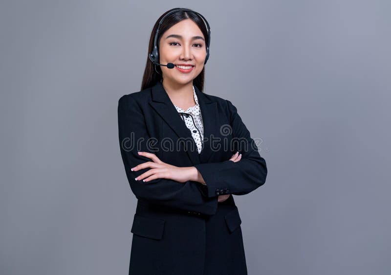 Attractive Asian operator with formal suit and headset. Jubilant royalty free stock photography