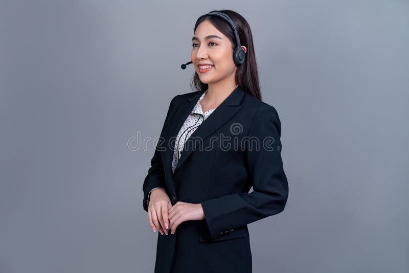 Attractive Asian operator with formal suit and headset. Jubilant stock image