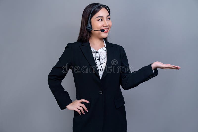Attractive Asian operator with formal suit and headset. Jubilant royalty free stock photos