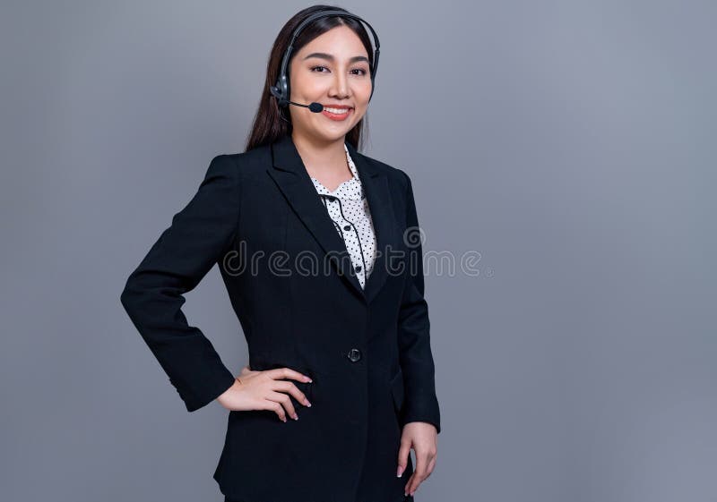 Attractive Asian operator with formal suit and headset. Jubilant royalty free stock photos
