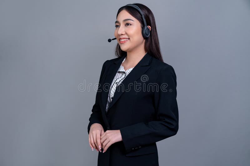Attractive Asian operator with formal suit and headset. Jubilant stock image