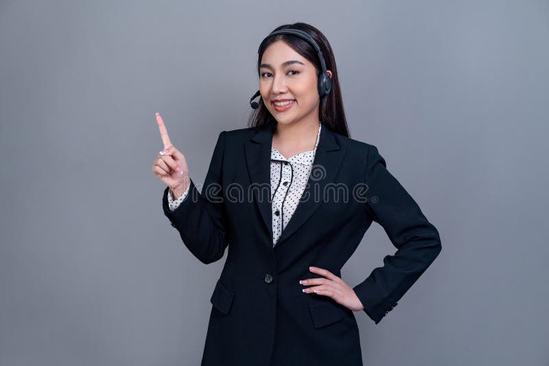 Attractive Asian operator with formal suit and headset. Jubilant royalty free stock photo