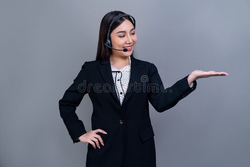 Attractive Asian operator with formal suit and headset. Jubilant royalty free stock photos