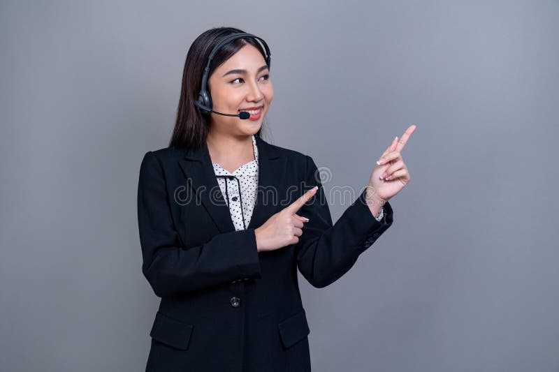 Attractive Asian operator with formal suit and headset. Jubilant royalty free stock photos