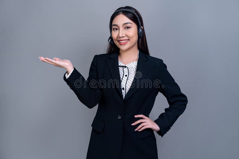 Attractive Asian operator with formal suit and headset. Jubilant stock images