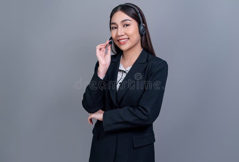 Attractive Asian operator with formal suit and headset. Jubilant royalty free stock photos