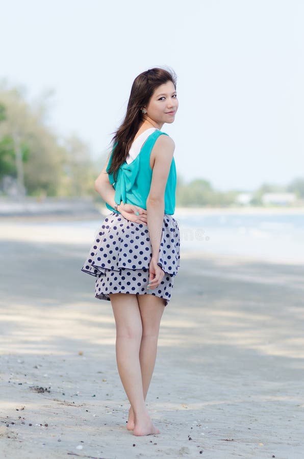 Attractive Asian woman enjoy on the beach