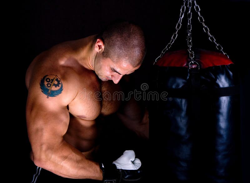 Attractive athletic young man training kickboxing