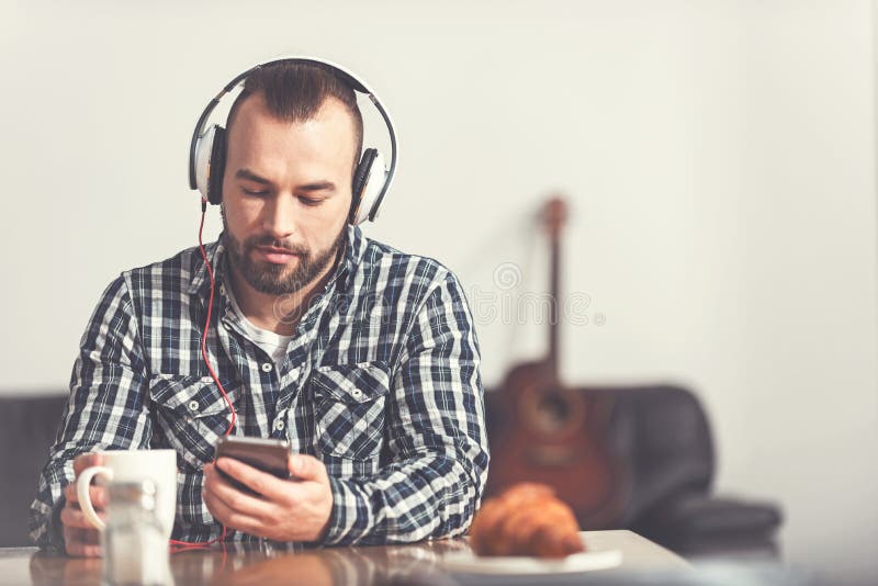 Attractive bearded man listening to music stock photos Attractive bearded man listening to music stock photos