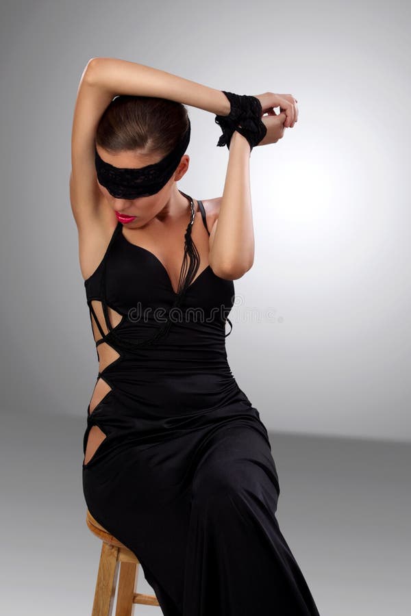Attractive blindfolded girl sitting