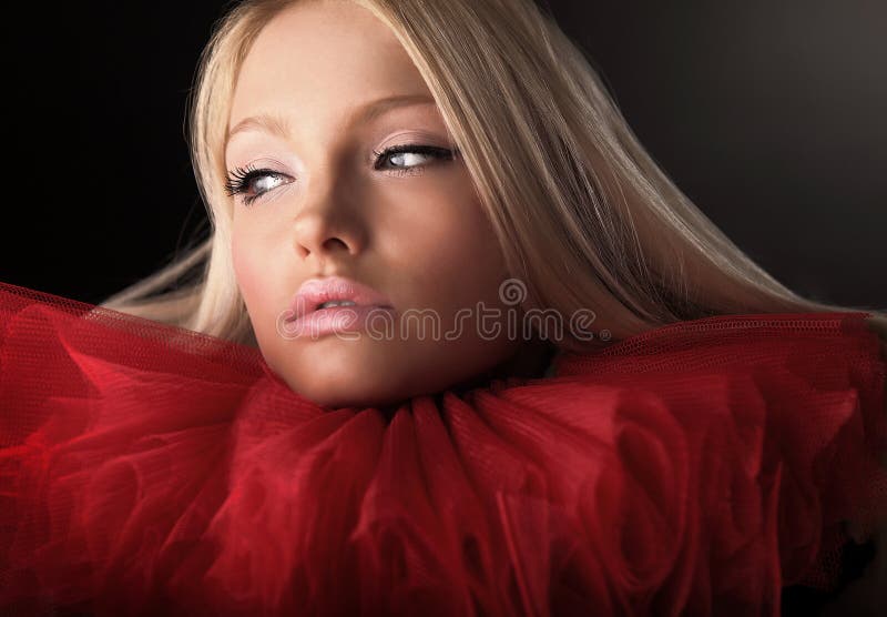 Attractive blond beauty in red theatrical jabot