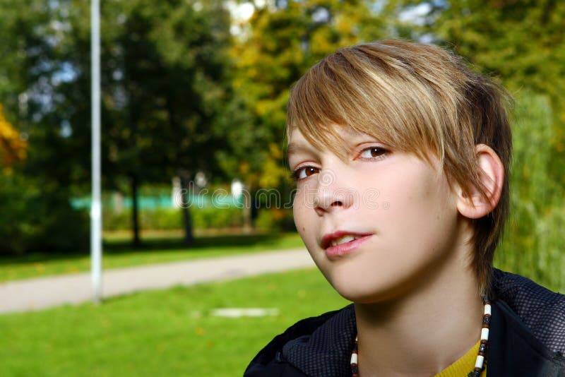 Attractive blond boy in park royalty free stock image Attractive blond boy in park royalty free stock image