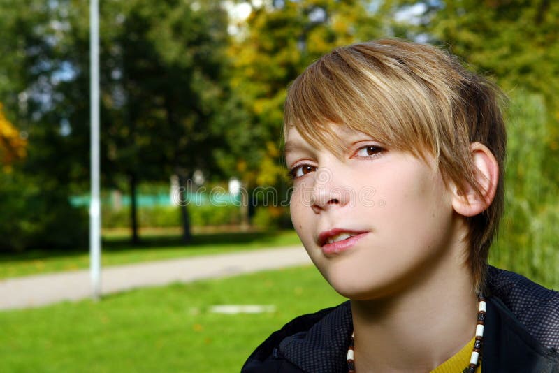 Attractive blond boy in park