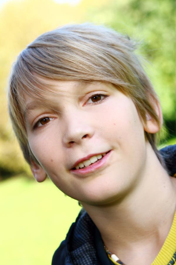 Attractive blond boy in park