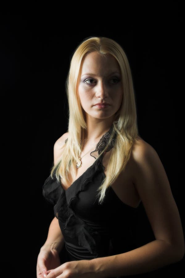 Attractive blond model on black background