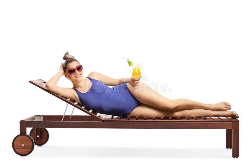 Attractive blond woman with sunglasses lying on a sunbed and holding a cocktail stock images Attractive blond woman with sunglasses lying on a sunbed and holding a cocktail stock images