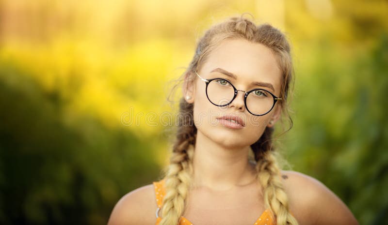 Attractive Blonde Young Woman With Natural Face Makeup Wearing Stylish Fashion Optical Eye Glasses. Copy space and summer autumn royalty free stock images Attractive Blonde Young Woman With Natural Face Makeup Wearing Stylish Fashion Optical Eye Glasses. Copy space and summer autumn royalty free stock images