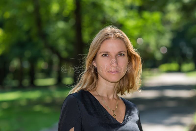 Attractive blonde young woman in a park stock photography Attractive blonde young woman in a park stock photography