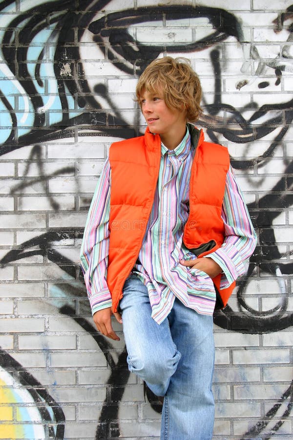 Attractive boy leaning against a wall stock photography Attractive boy leaning against a wall stock photography