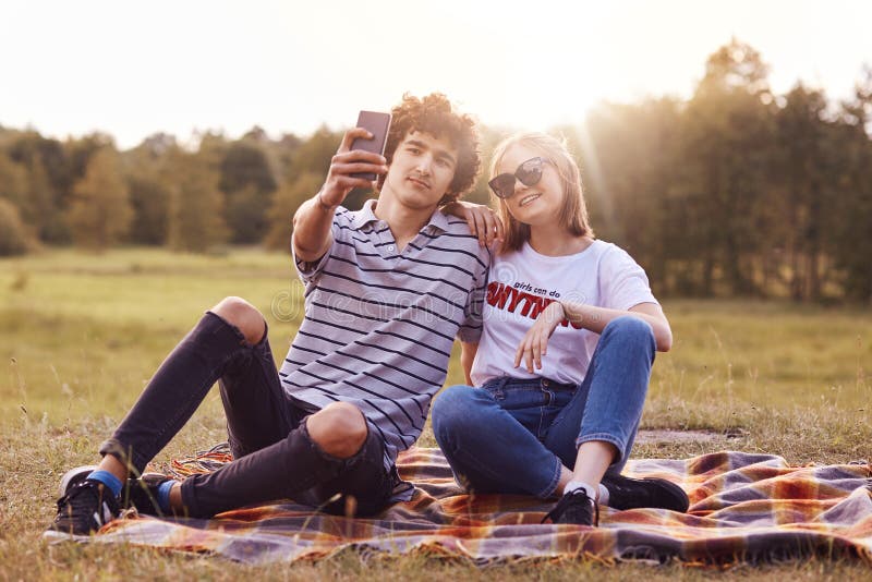 Romantic boyfriend embracing girlfriend stock photo