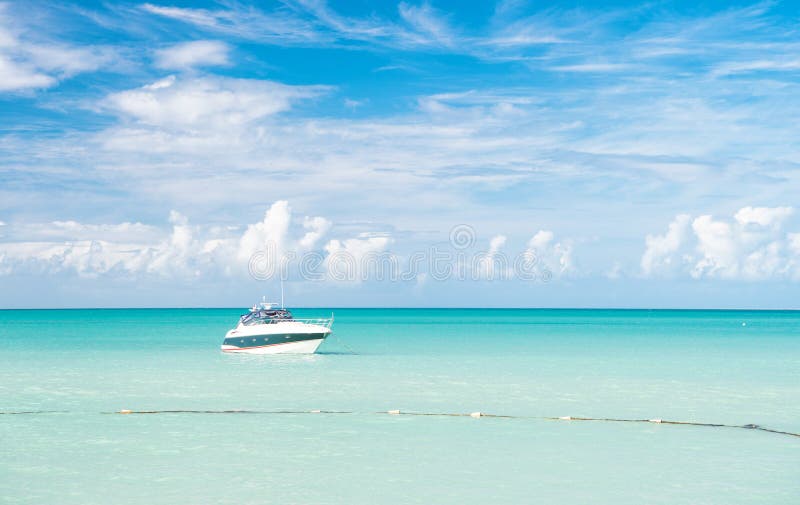 Attractive bright view of exotic colorful beautiful marine beach with boat on blue water