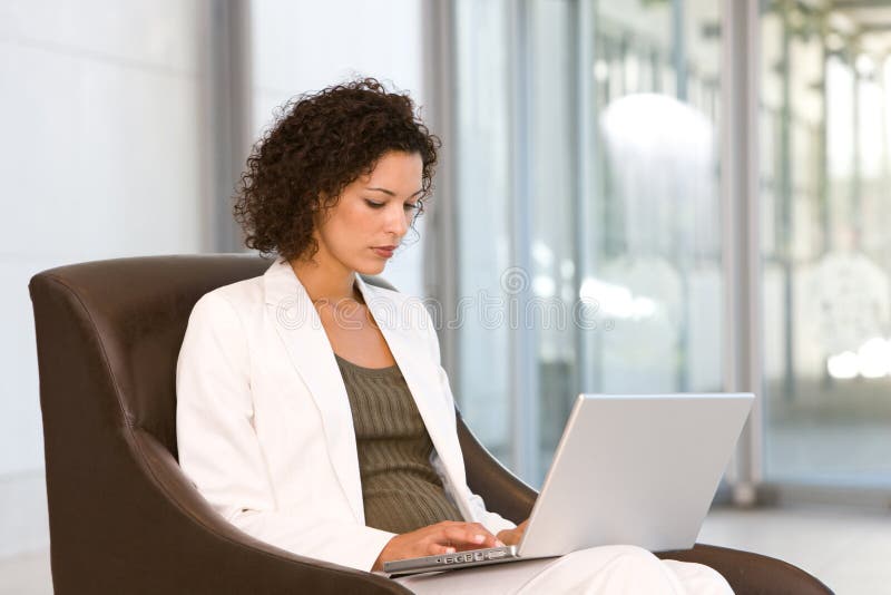 Attractive business woman working on laptop stock photography Attractive business woman working on laptop stock photography