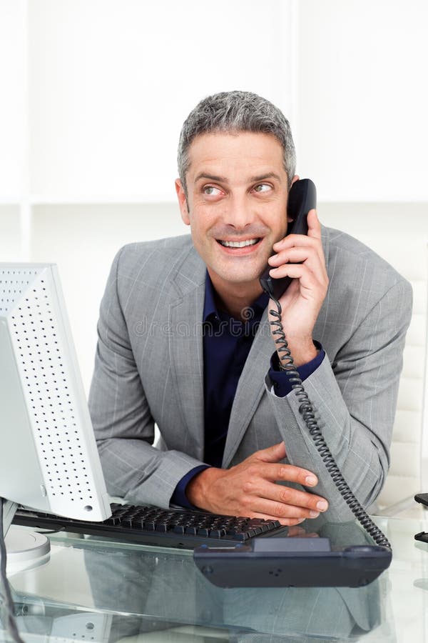 Attractive businessman on phone at his desk