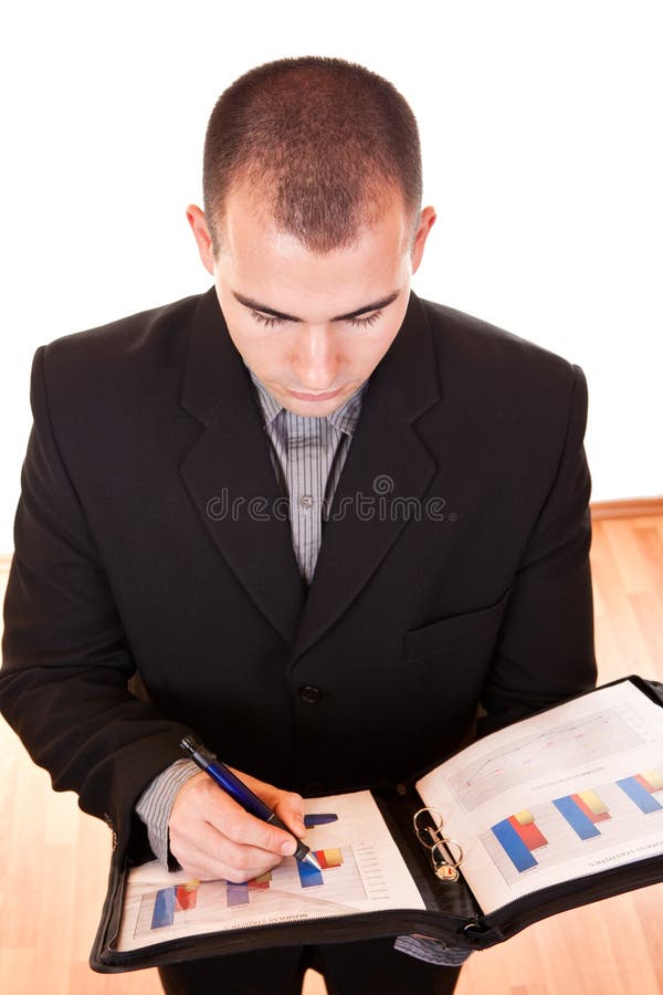 Attractive businessman writing on documents