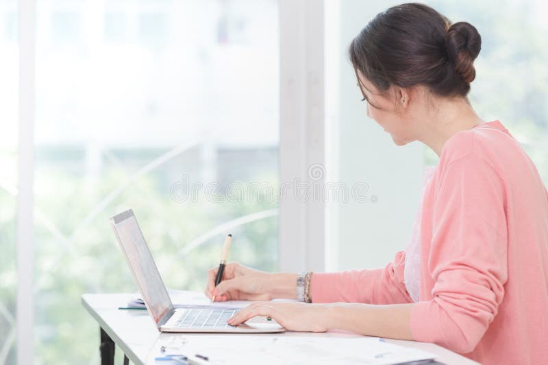 Attractive businesswoman sitting working stock photography Attractive businesswoman sitting working stock photography
