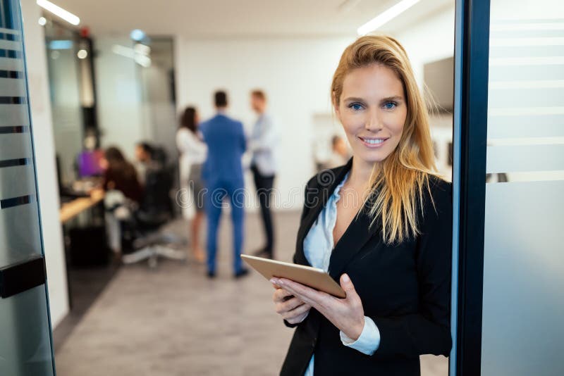 Attractive businesswoman using digital tablet in office stock images Attractive businesswoman using digital tablet in office stock images