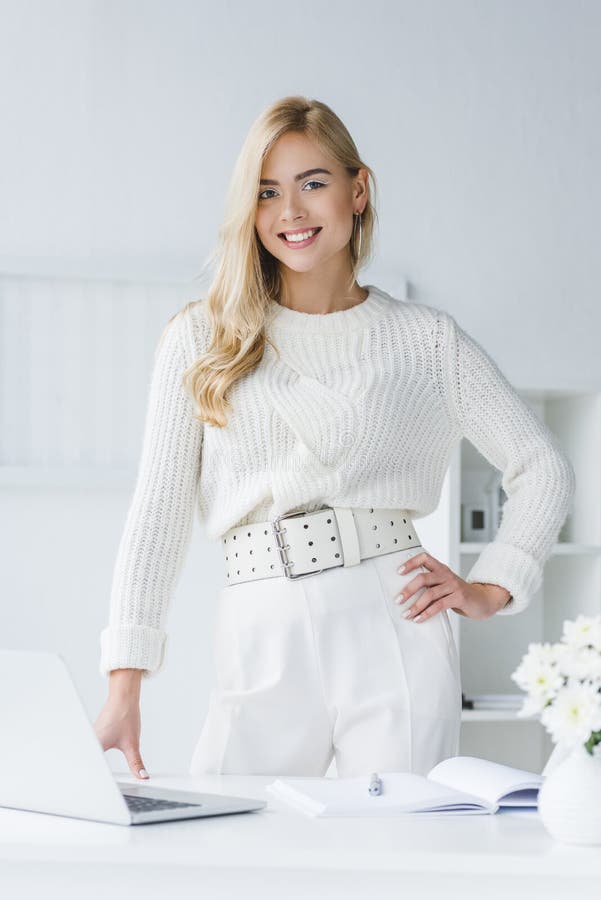attractive businesswoman in white clothes standing at workplace royalty free stock photo attractive businesswoman in white clothes standing at workplace royalty free stock photo