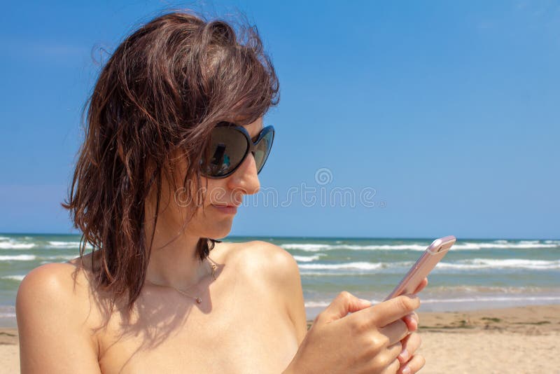 Appealing naked babes are relaxing on the beach