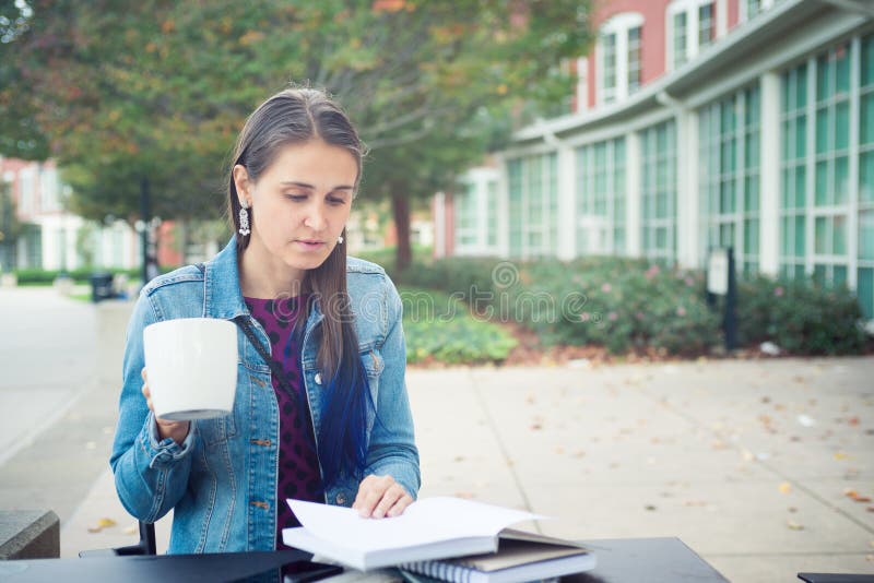 Attractive confident young woman reading book in street cafe royalty free stock images Attractive confident young woman reading book in street cafe royalty free stock images