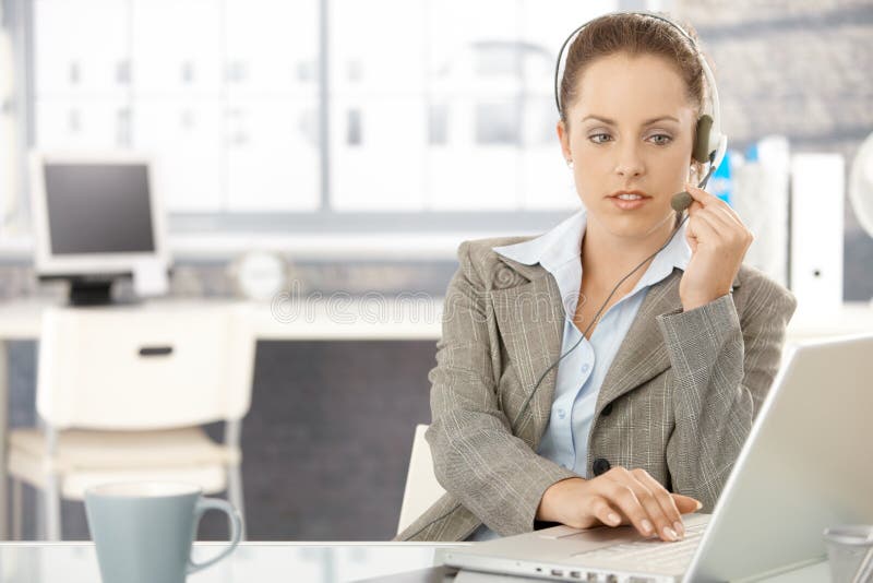 Attractive dispatcher working in bright office stock photography Attractive dispatcher working in bright office stock photography
