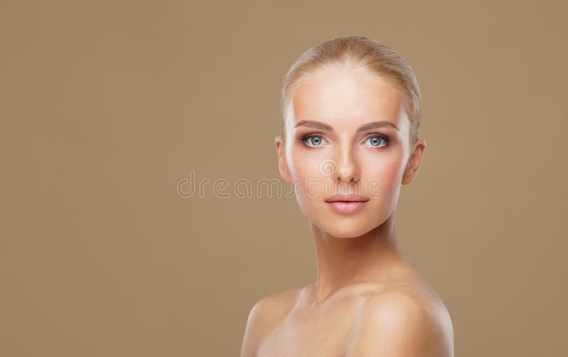 Attractive face of beautiful girl. Close-up portrait of healthy woman. Skin care, cosmetics, makeup, complexion and face