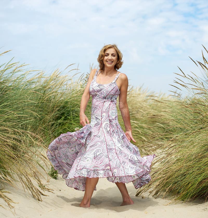 Attractive female dancing at the beach