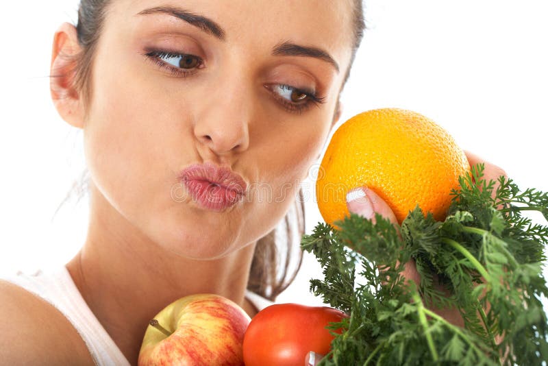 Attractive female holds bunch of fruit and veg